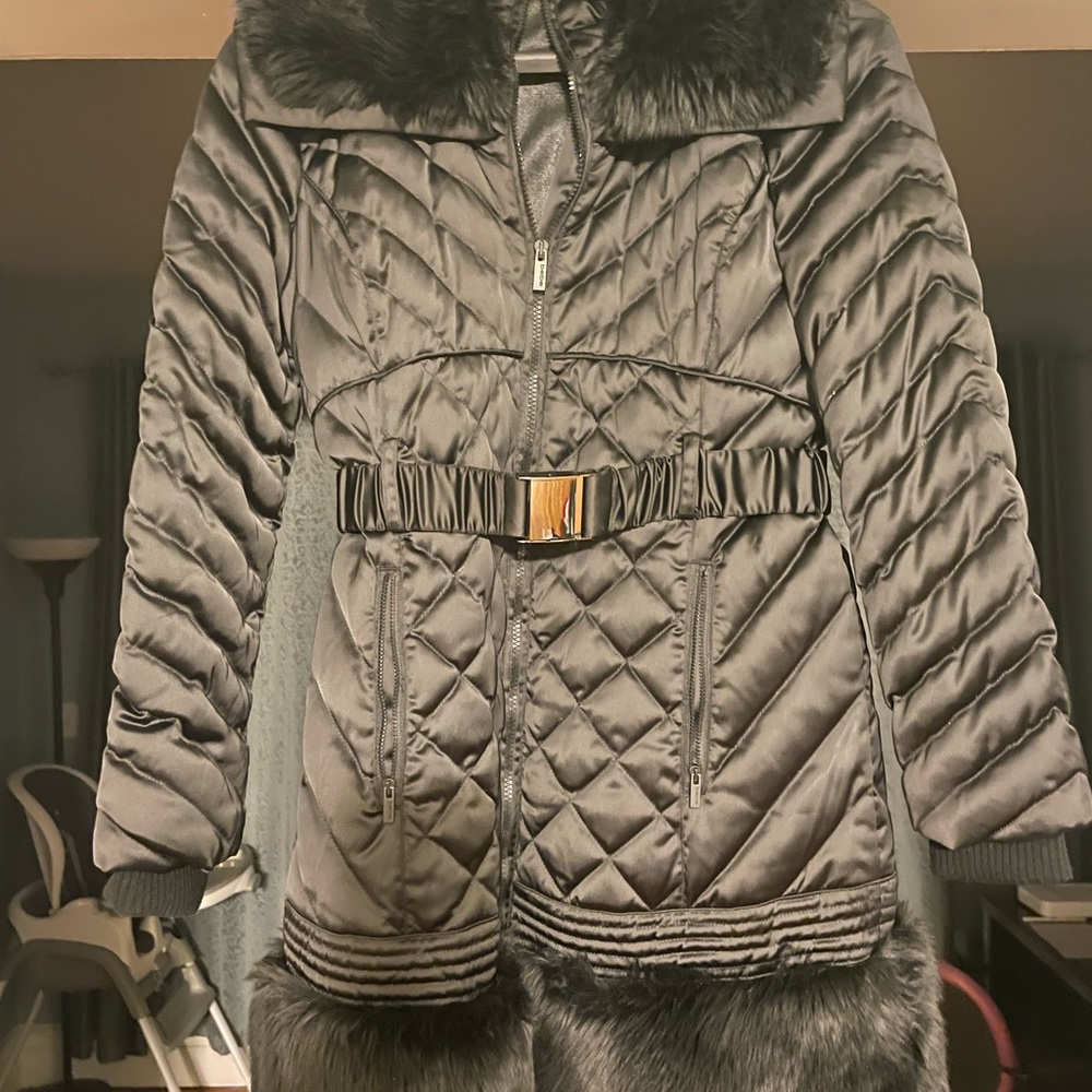 Black puffer coat, faux fur around neck and bottom, thumb holes. Very warm.